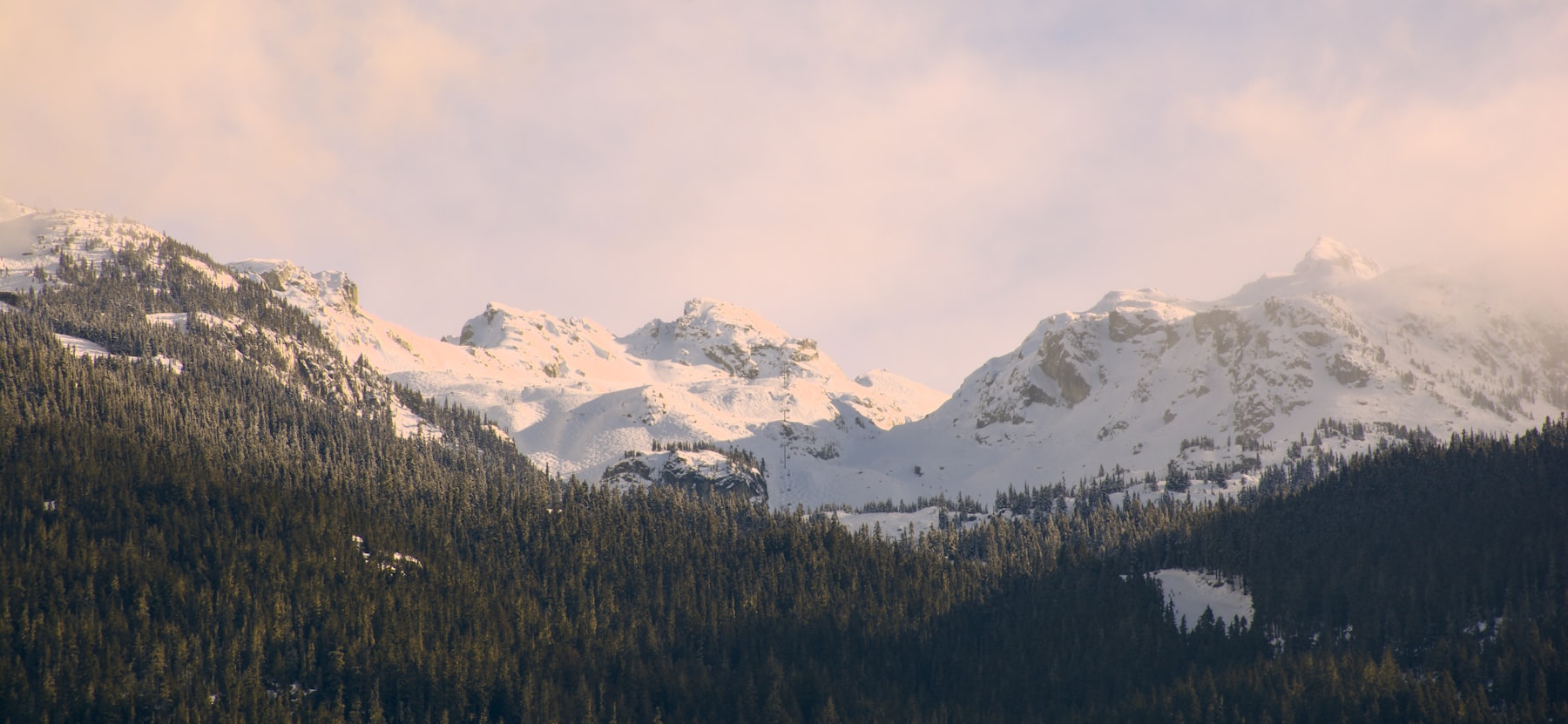 Snow-covered mountains above the forest in Whistler, BC
